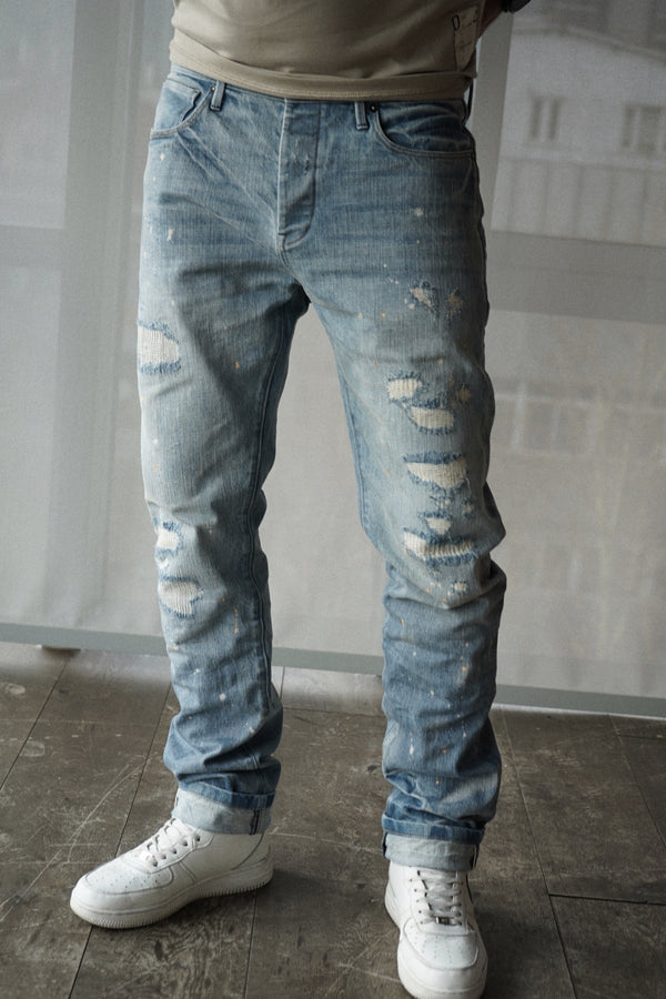 slim fit denim jeans with selvedge. light destroyed wash